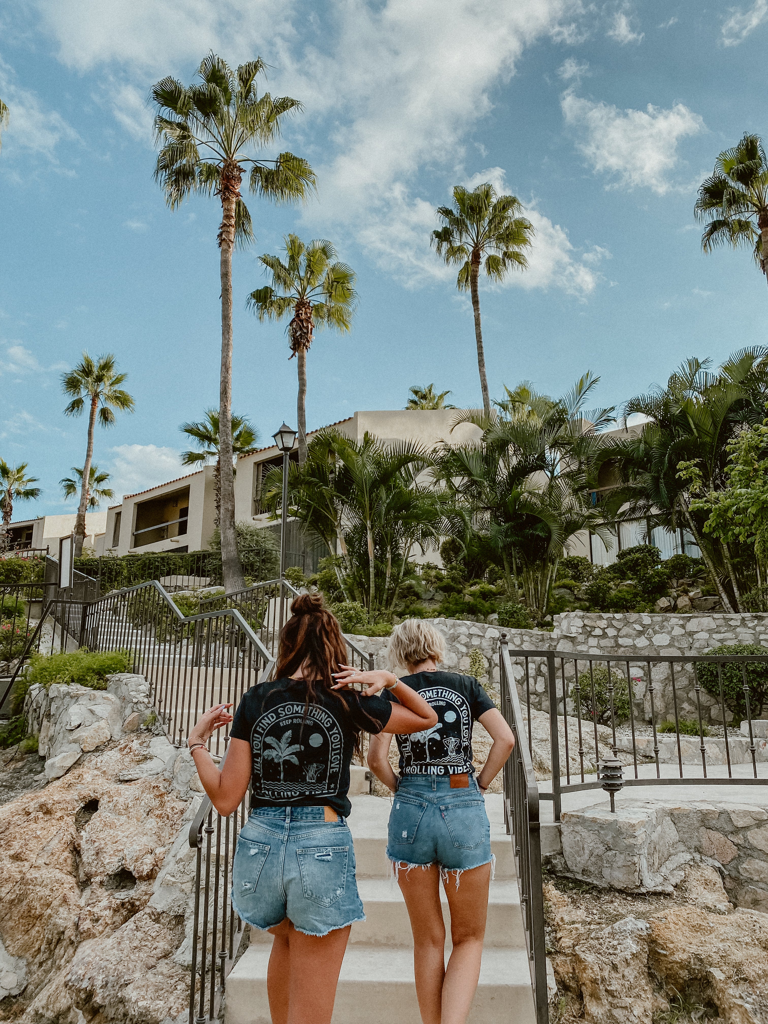 A casual tank top made of 100% cotton fabric with a relaxed fit. The design features a mermaid taking a bath surrounded by waves and palm trees on the back. The front is adorned with the Rolling Vibes logo. Perfect for a beachy, summer look.