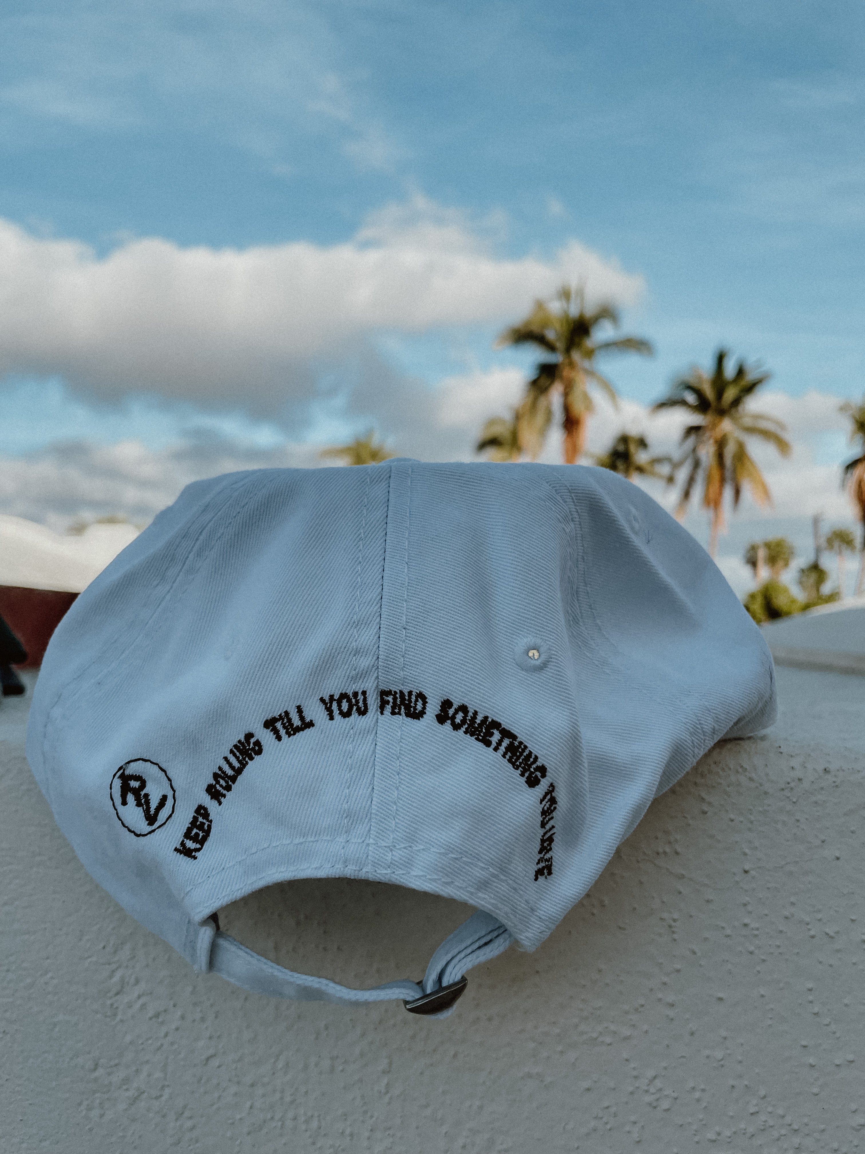 White Rolling Hat "Dad Hat" with Rolling Vibes logo on front and "keep rolling till you find something you love" on back