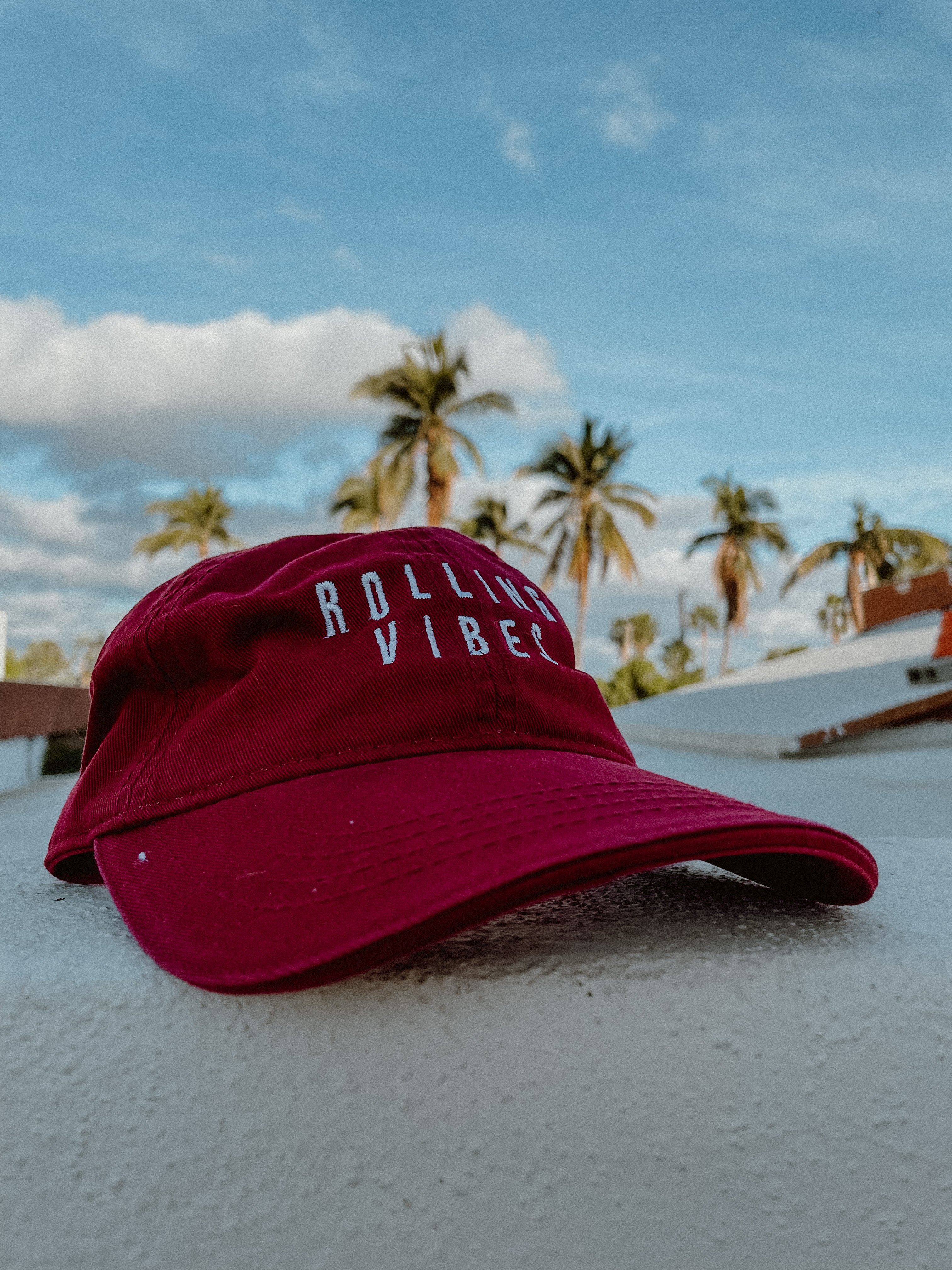 Red Rolling Hat "Dad Hat" with Rolling Vibes logo on front and "keep rolling till you find something you love" on back