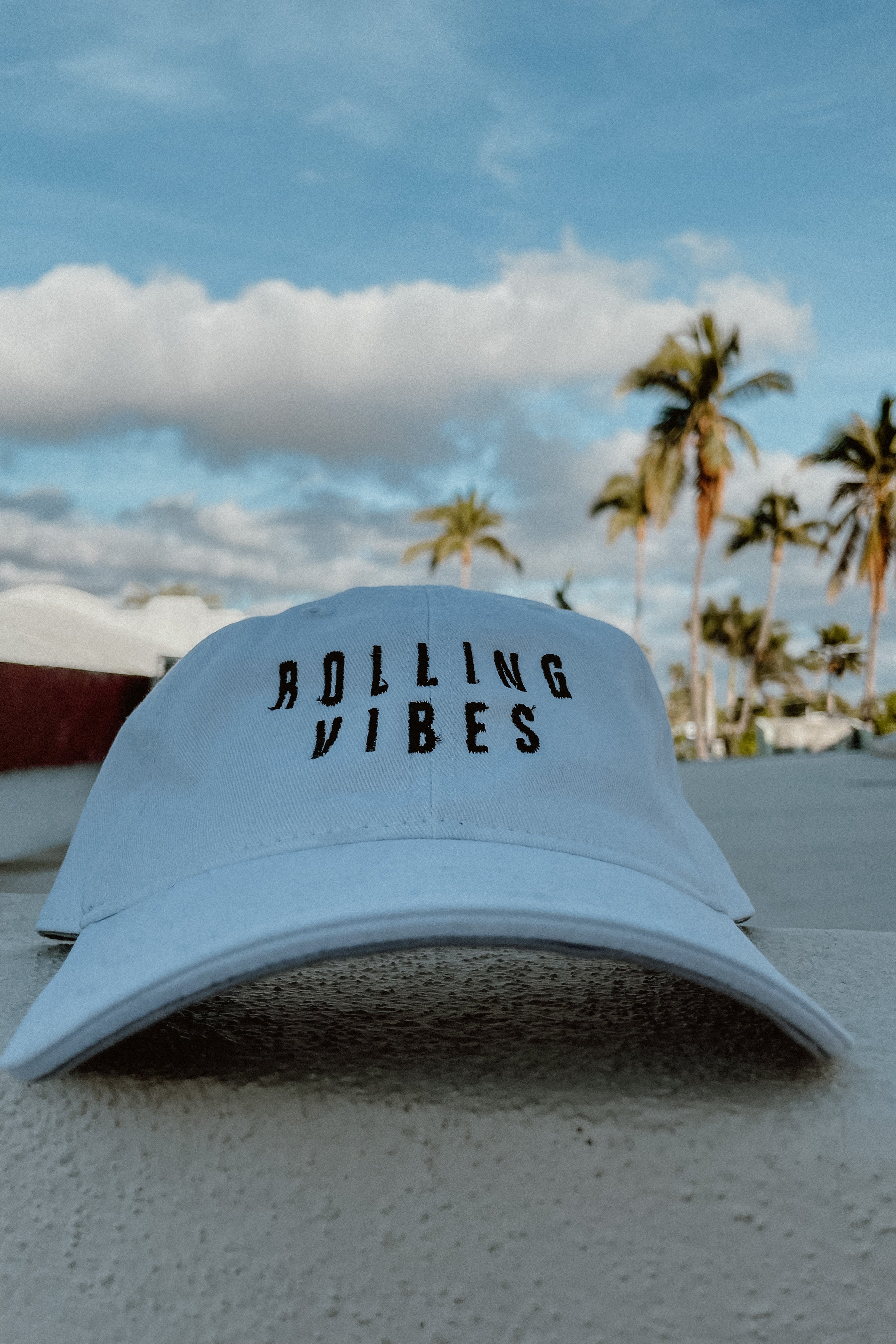 White Rolling Hat "Dad Hat" with Rolling Vibes logo on front and "keep rolling till you find something you love" on back