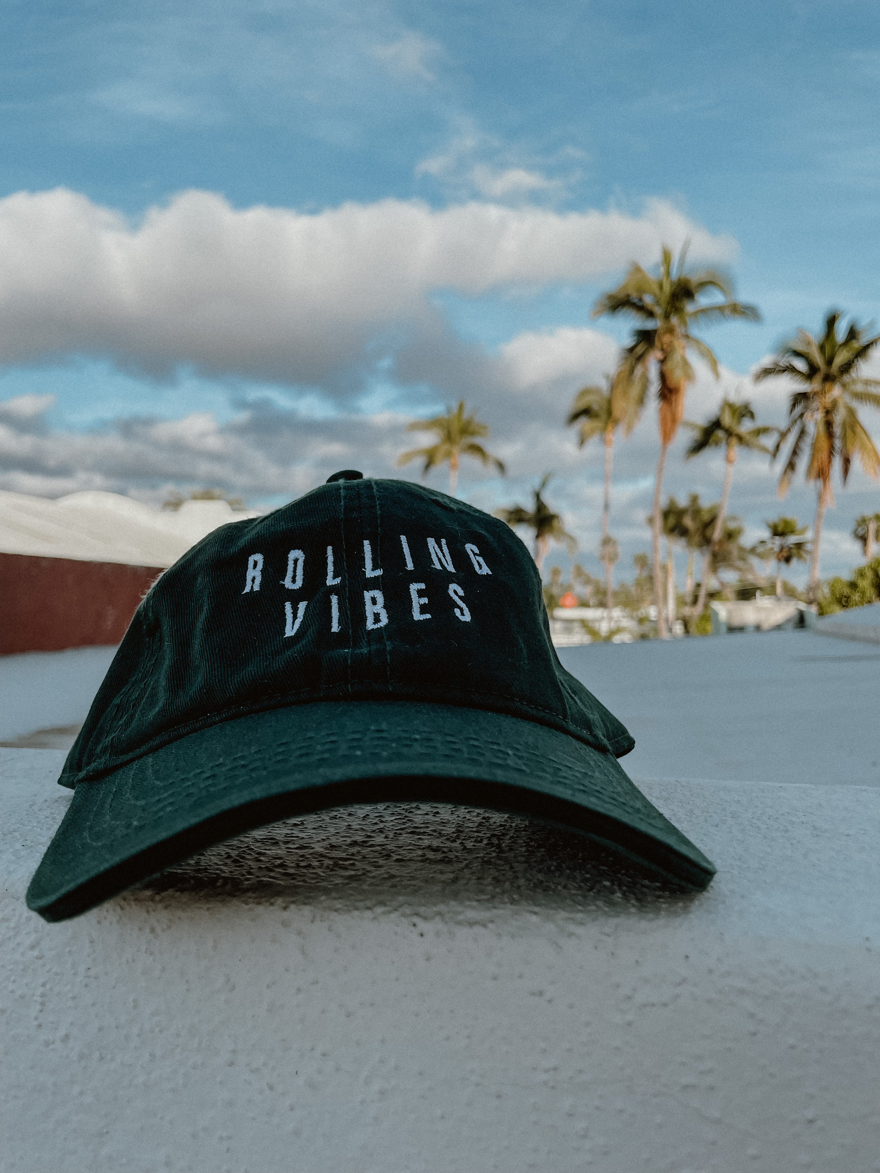 Green Rolling Hat "Dad Hat" with Rolling Vibes logo on front and "keep rolling till you find something you love" on back.